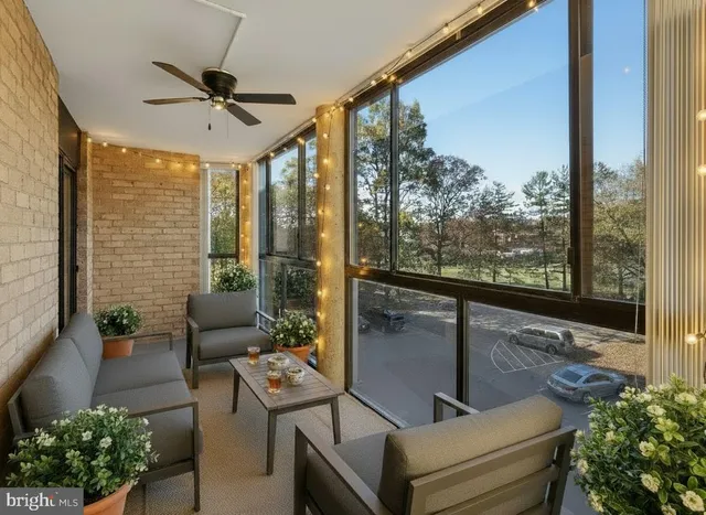 a view of a livingroom with wooden floor and a ceiling fan