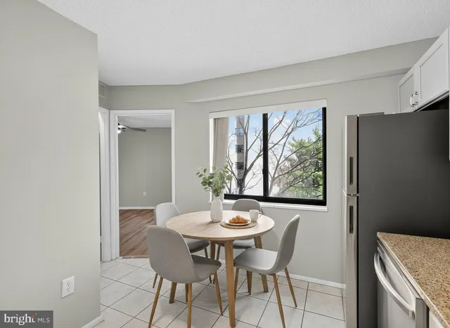 a view of an empty room with window and cabinet