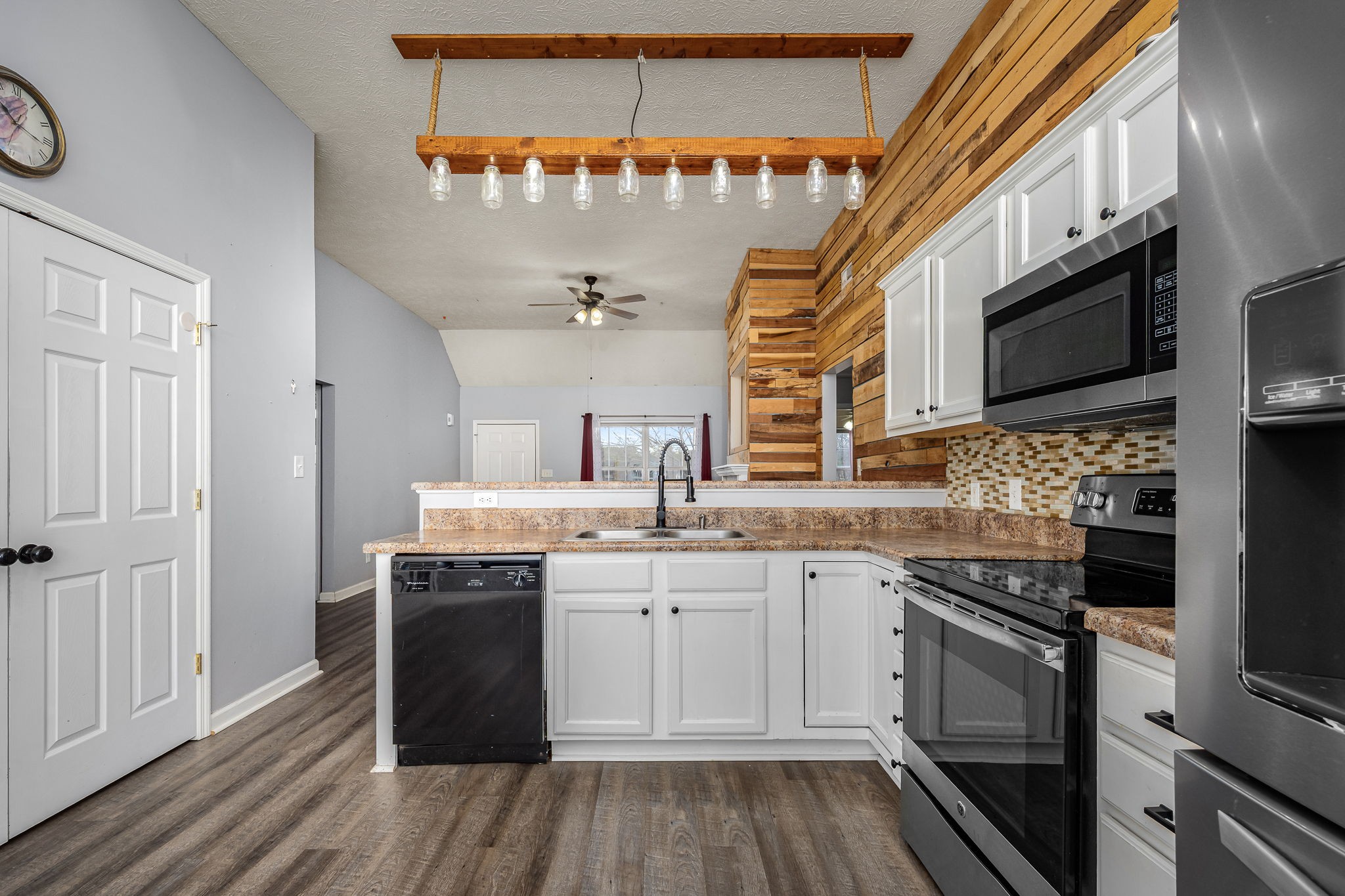 8100 Cedar Forest Road Lascassas, TN 37085 - Photo 15 of 52 a kitchen with stainless steel appliances granite countertop a sink and stove top oven