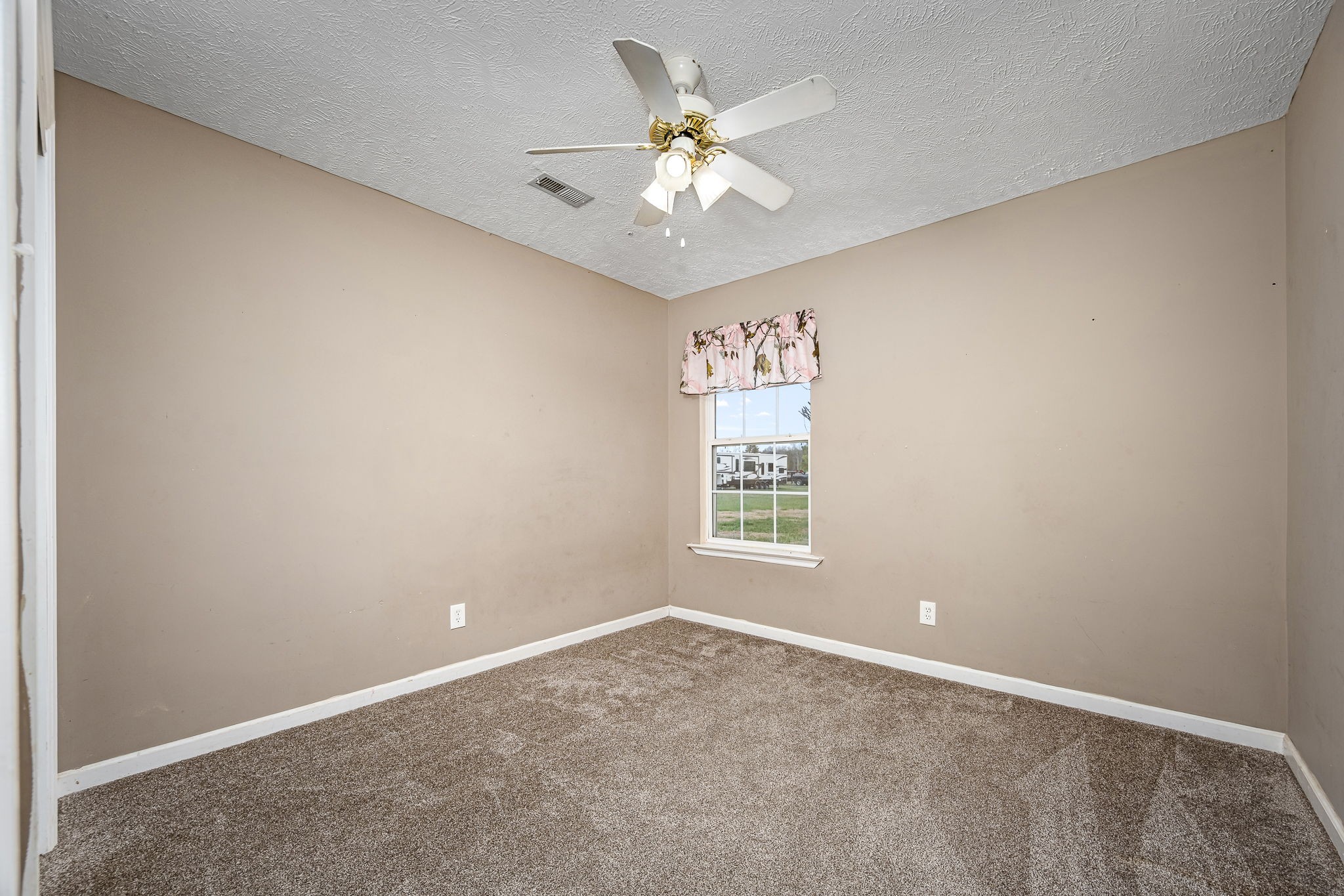 8100 Cedar Forest Road Lascassas, TN 37085 - Photo 26 of 52 an empty room with windows and chandelier fan