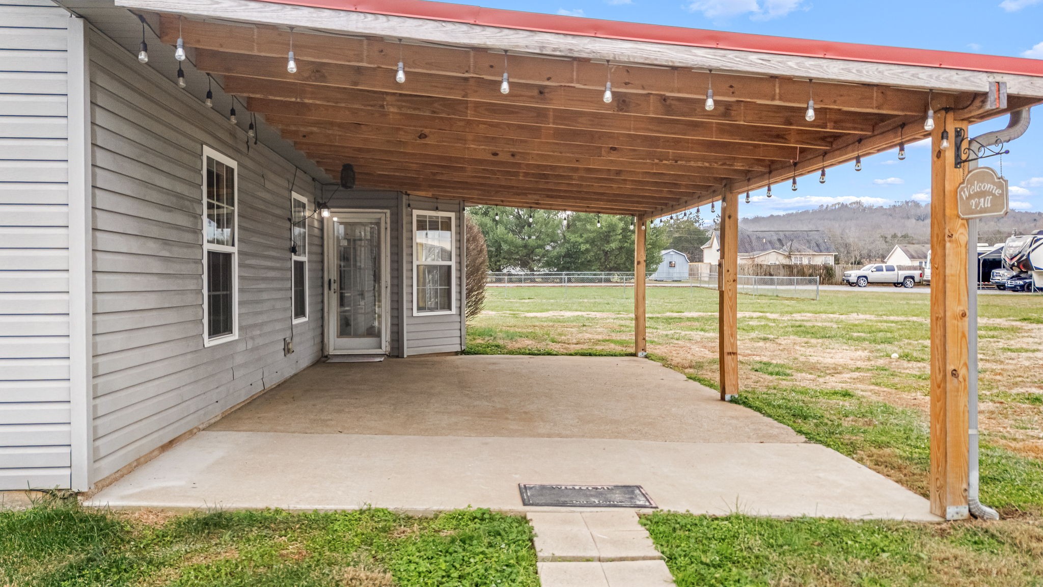 8100 Cedar Forest Road Lascassas, TN 37085 - Photo 38 of 52 a view of porch with a table and chairs under an umbrella