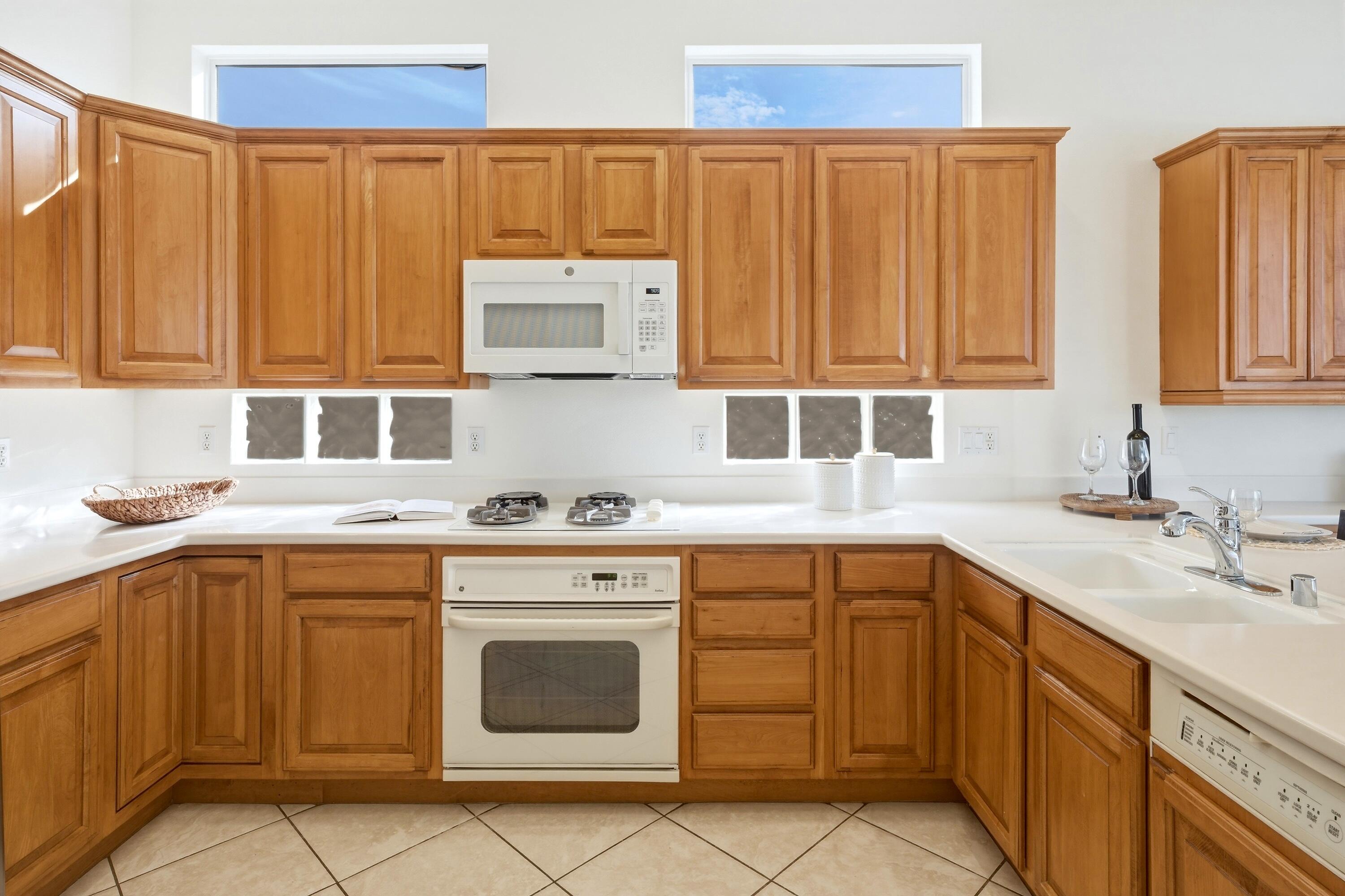 35440 Moorbrook Road Palm Desert, CA 92211 - Photo 16 of 32 a kitchen with a sink stove and cabinets