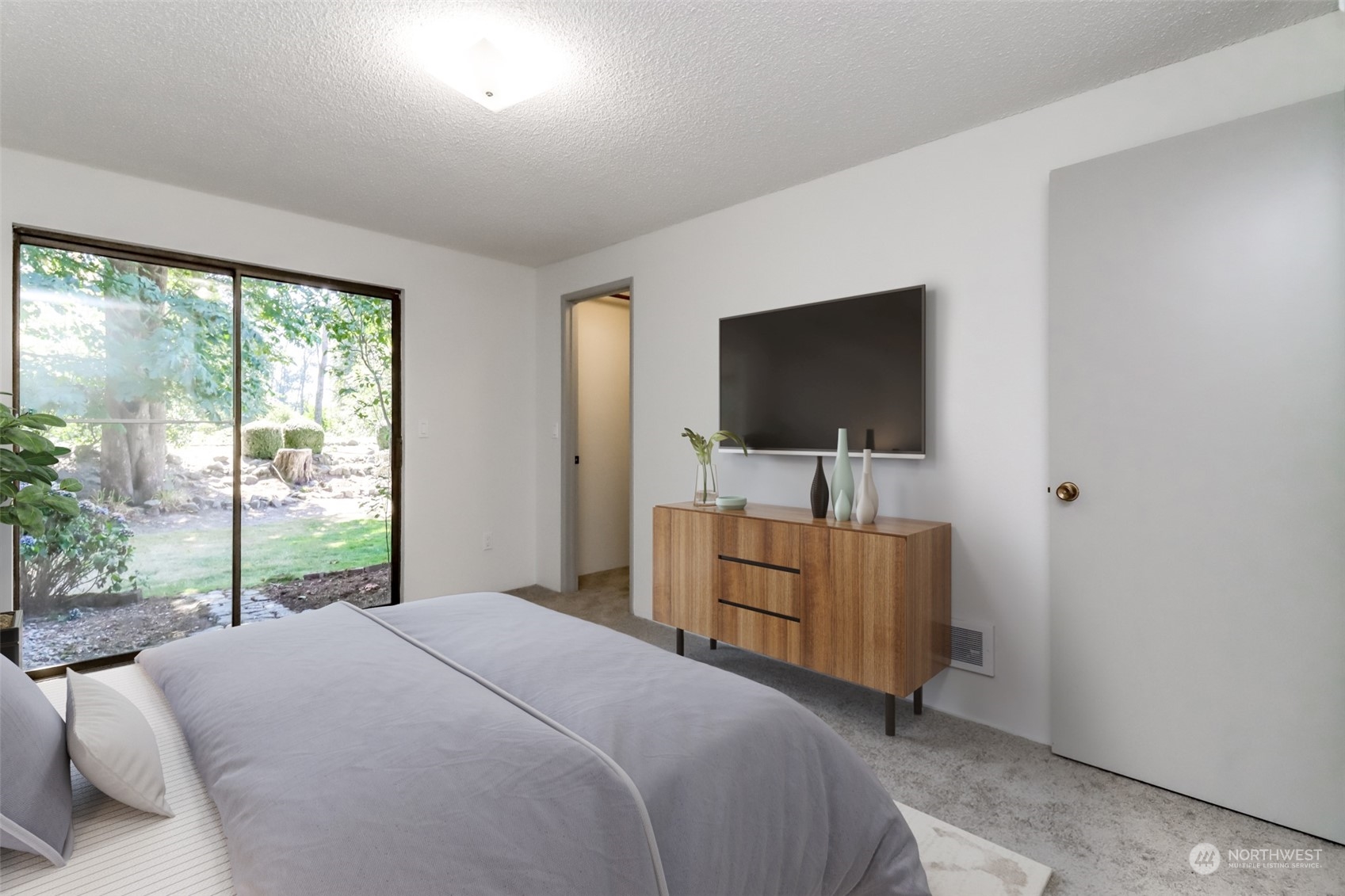 8521 South 259th Street, Unit B15 Kent, WA 98030 - Photo 11 of 26 a bedroom with a bed and a flat screen tv