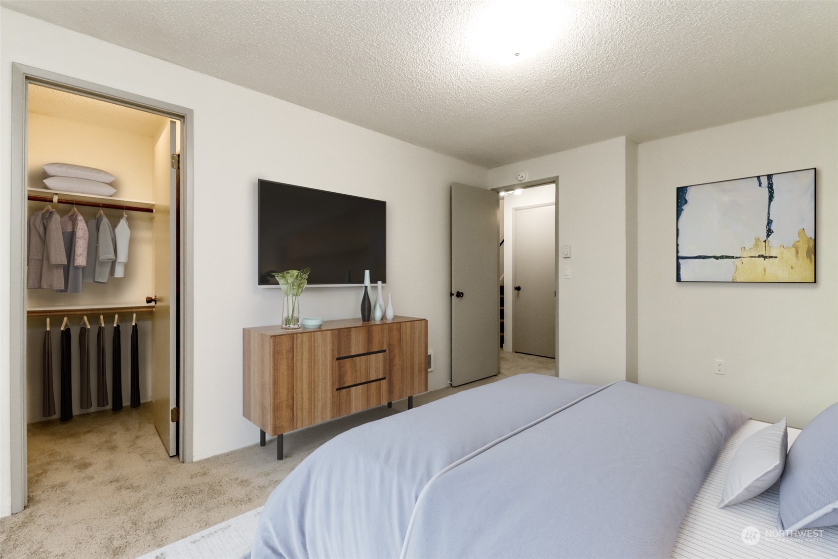 8521 South 259th Street, Unit B15 Kent, WA 98030 - Photo 13 of 26 a bedroom with a bed and a flat screen tv