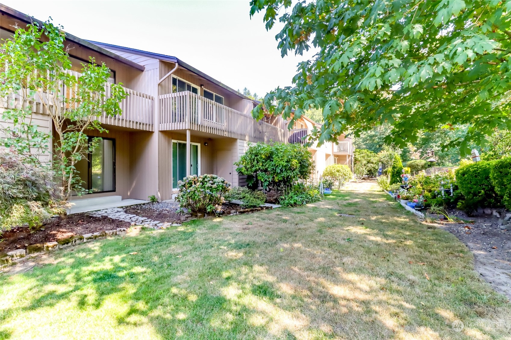 8521 South 259th Street, Unit B15 Kent, WA 98030 - Photo 20 of 26 a view of a house with a yard