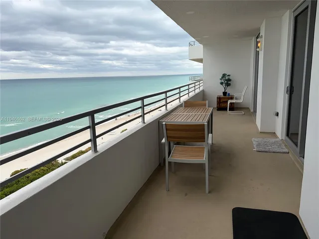 a view of a chairs and table in the balcony
