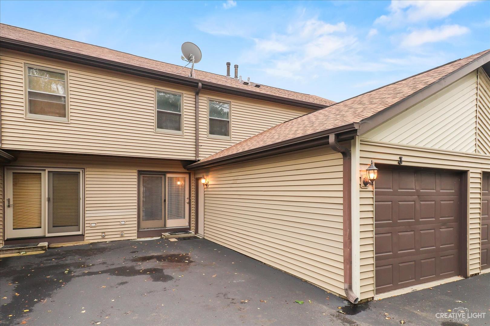 150 Eagle Point Road, Unit J Fox Lake, IL 60020 - Photo 1 of 16 a view of a white house