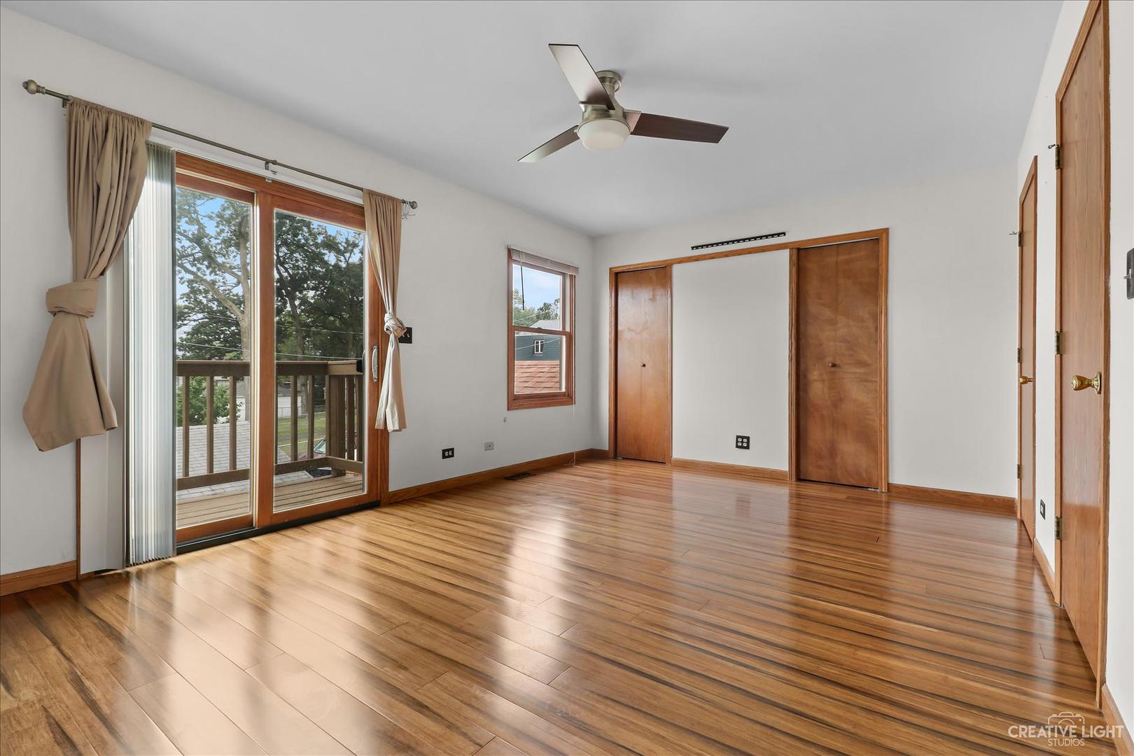 150 Eagle Point Road, Unit J Fox Lake, IL 60020 - Photo 5 of 16 a view of empty room with wooden floor and fan