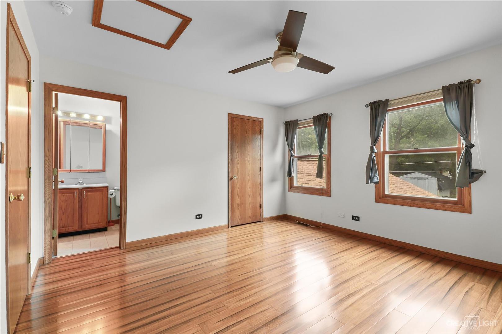150 Eagle Point Road, Unit J Fox Lake, IL 60020 - Photo 10 of 16 a view of an empty room with window and wooden floor