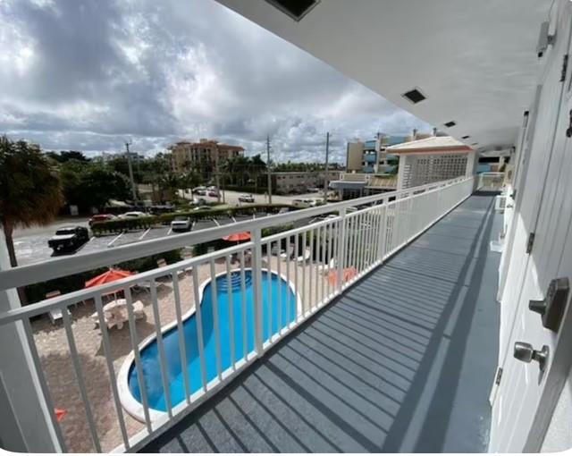 120 Northeast 20th Avenue, Unit 30 Deerfield Beach, FL 33441 - Photo 13 of 14 a balcony with wooden floor and city view