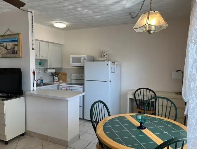 120 Northeast 20th Avenue, Unit 30 Deerfield Beach, FL 33441 - Photo 4 of 14 a dining room with furniture and a chandelier