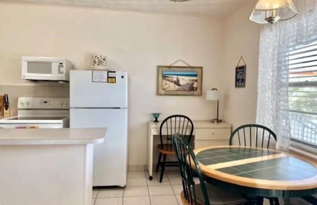 120 Northeast 20th Avenue, Unit 30 Deerfield Beach, FL 33441 - Photo 5 of 14 a view of a dining room with furniture and a window