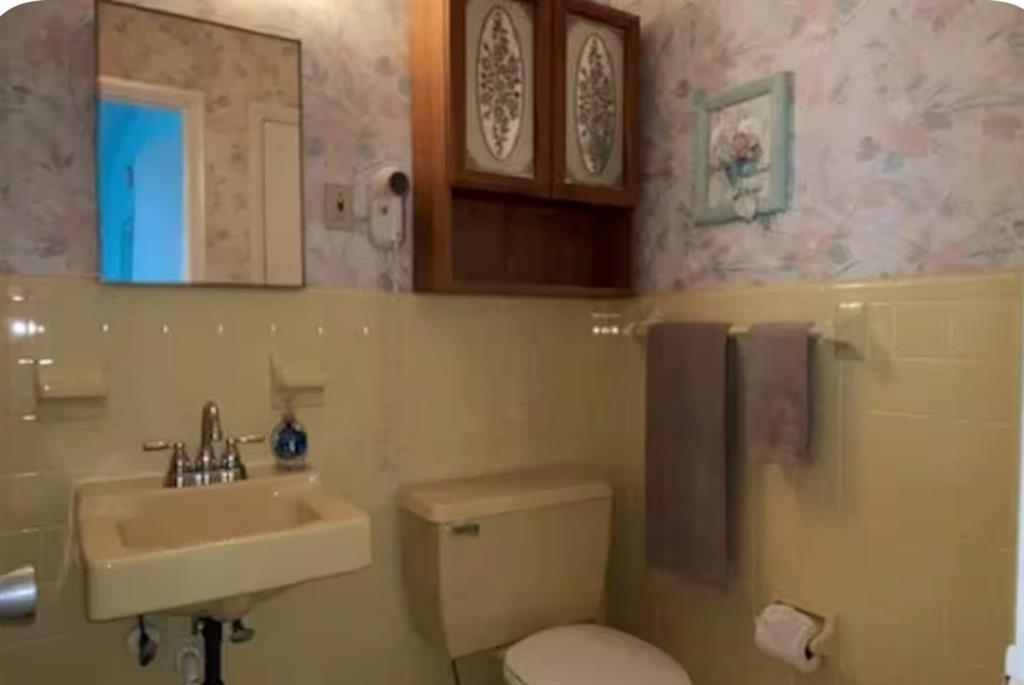 120 Northeast 20th Avenue, Unit 30 Deerfield Beach, FL 33441 - Photo 9 of 14 a bathroom with a toilet sink and mirror
