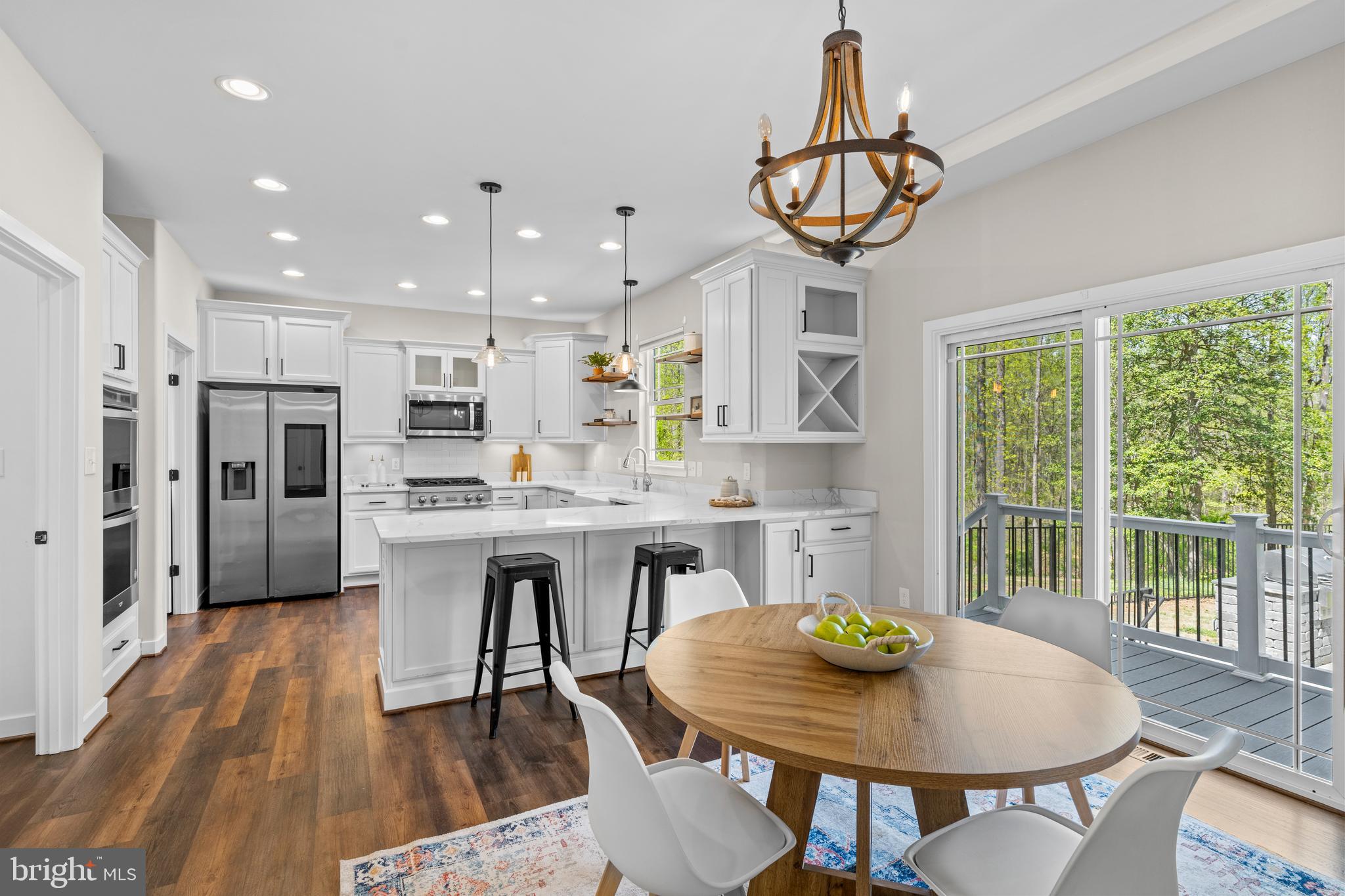 7195 Compass Court King George, VA 22485 - Photo 11 of 58 a kitchen with stainless steel appliances a dining table chairs and window
