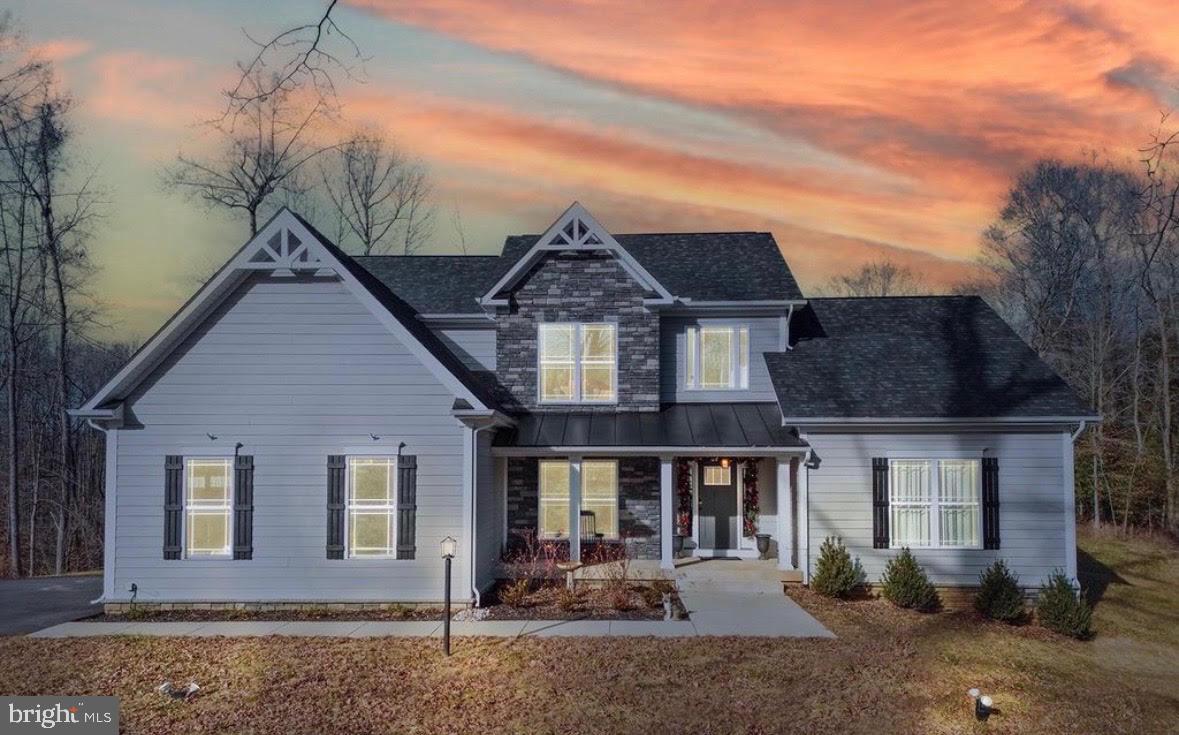 7195 Compass Court King George, VA 22485 - Photo 2 of 58 a front view of a house with garden