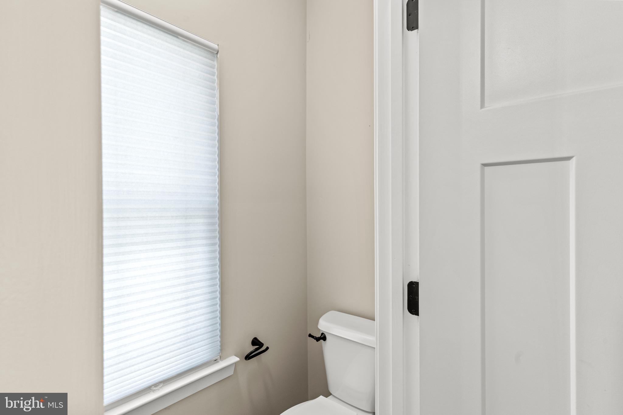 7195 Compass Court King George, VA 22485 - Photo 23 of 58 a white toilet sitting next to a bathroom sink