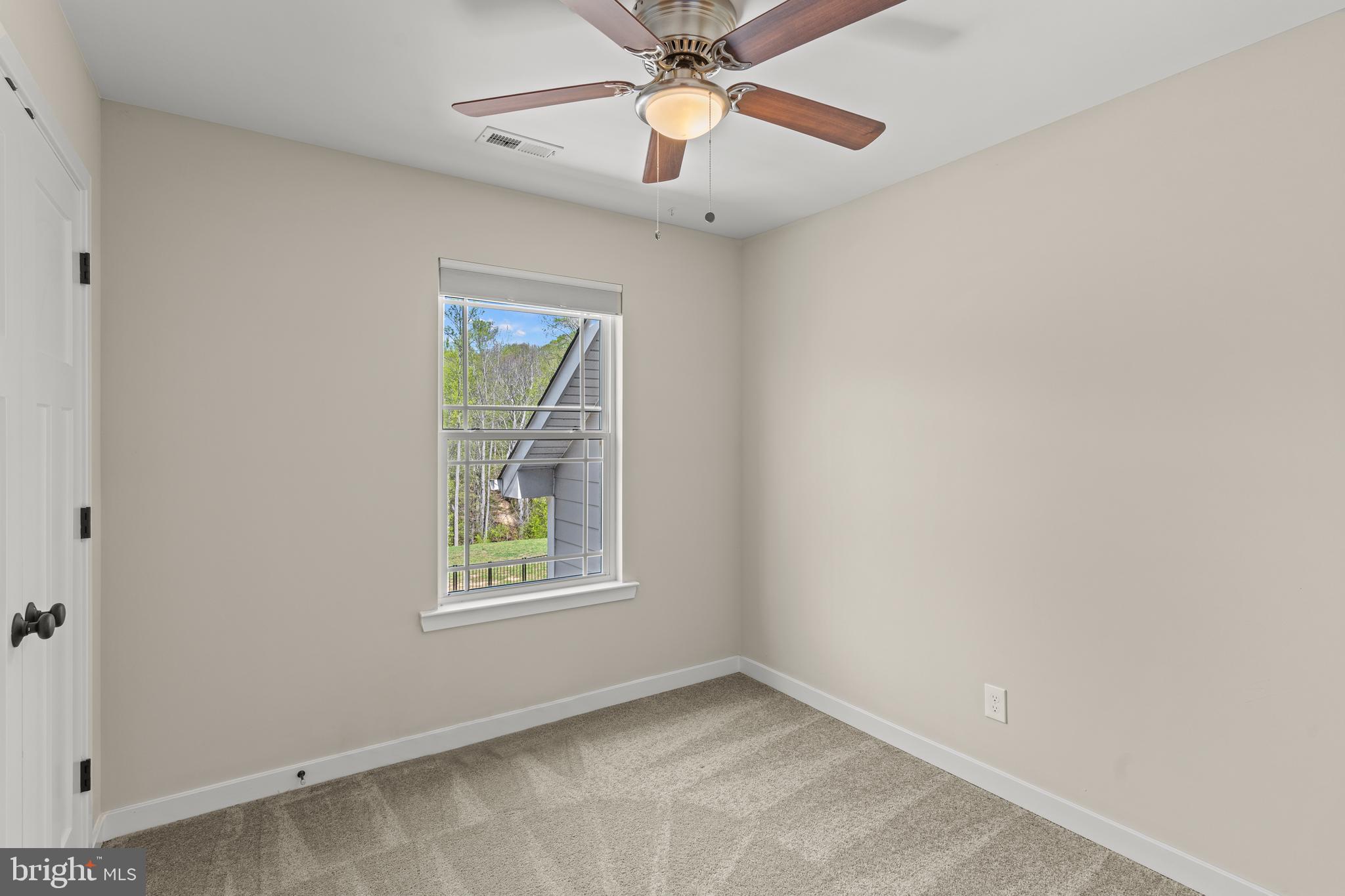 7195 Compass Court King George, VA 22485 - Photo 28 of 58 an empty room with windows and fan