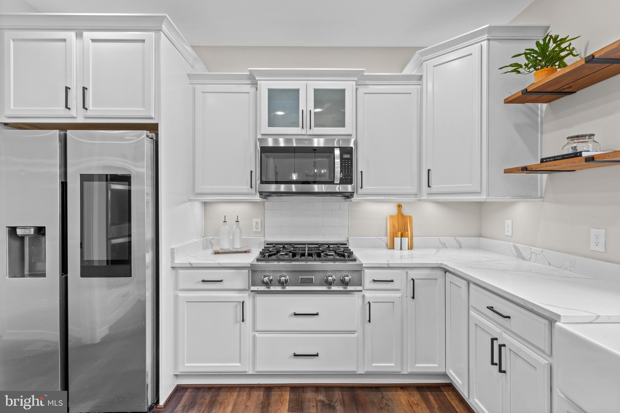 7195 Compass Court King George, VA 22485 - Photo 9 of 58 a kitchen with white cabinets and appliances