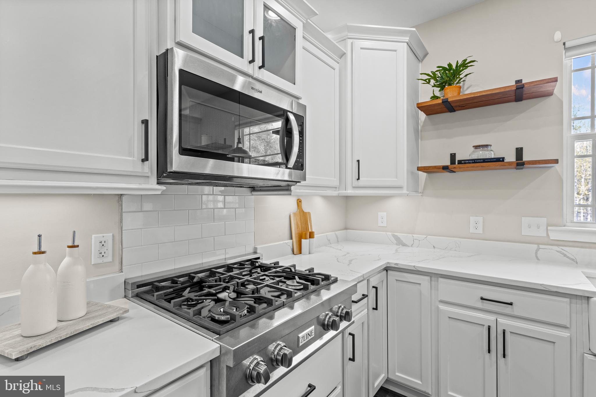 7195 Compass Court King George, VA 22485 - Photo 10 of 58 a kitchen with stainless steel appliances a stove and cabinets