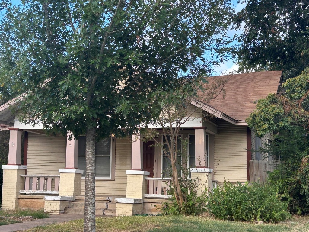 front view of house with a tree