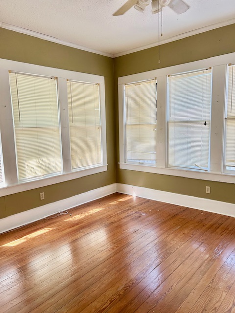 413 Fowzer Street Taylor, TX 76574 - Photo 7 of 9 a view of an empty room with wooden floor and a window