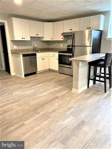 a kitchen with stainless steel appliances granite countertop a refrigerator sink and stove