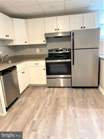a white refrigerator freezer sitting in a kitchen