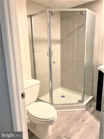 a bathroom with a toilet and a shower