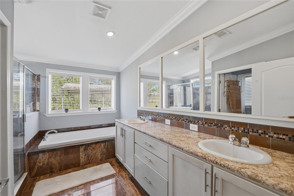 6844 Chad Jason Road St. Cloud, FL 34773 - Photo 33 of 59 a bathroom with a granite countertop sink and a large mirror