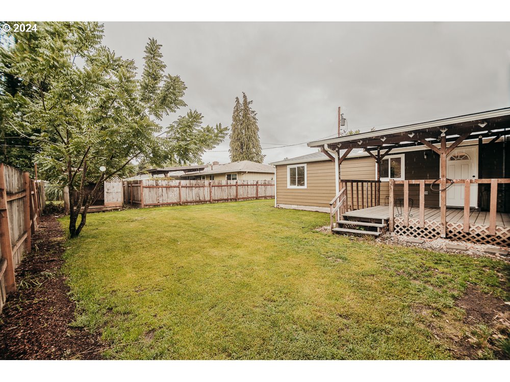 901 25th Street Springfield, OR 97477 - Photo 26 of 27 a view of a house with backyard and trees