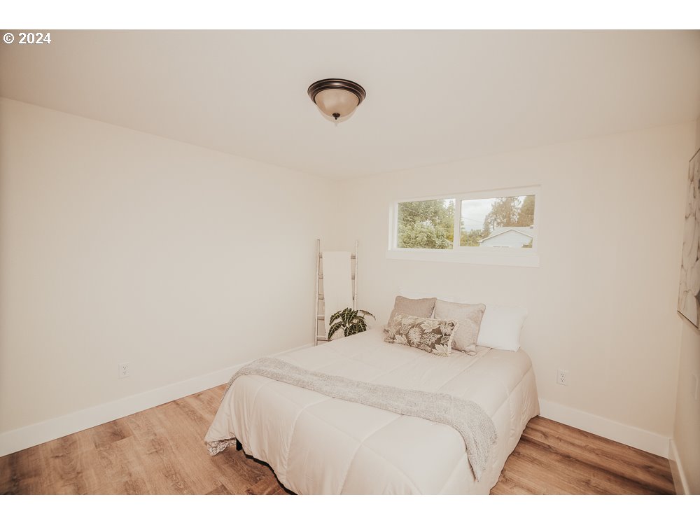 901 25th Street Springfield, OR 97477 - Photo 10 of 27 a bedroom with a bed and a wall painting