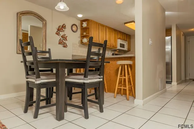 a living room with furniture a flat screen tv and a window