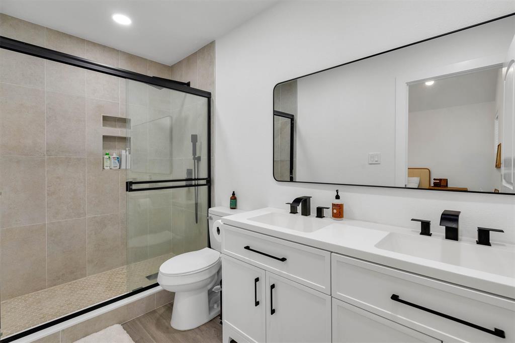 801 Southeast 4th Street Cooper, TX 75432 - Photo 24 of 37 a bathroom with a toilet sink and shower