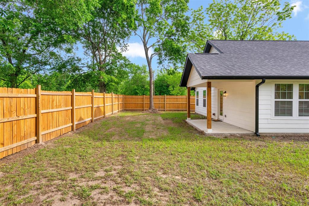 801 Southeast 4th Street Cooper, TX 75432 - Photo 29 of 37 a view of a backyard with a small cabin