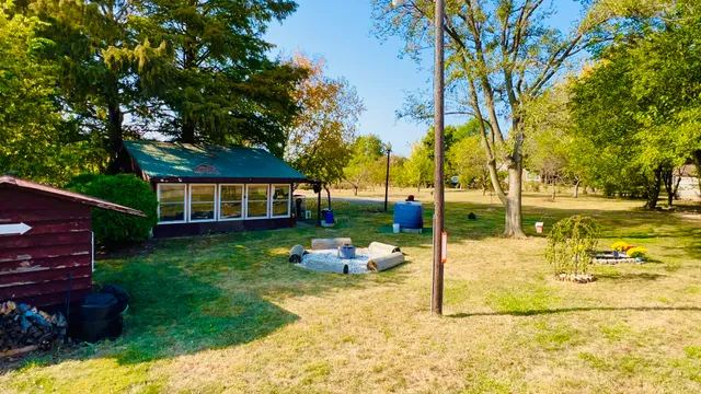 a backyard of a house with table and chairs