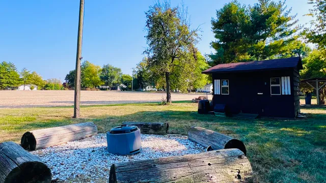 a view of a house with a tree and yard
