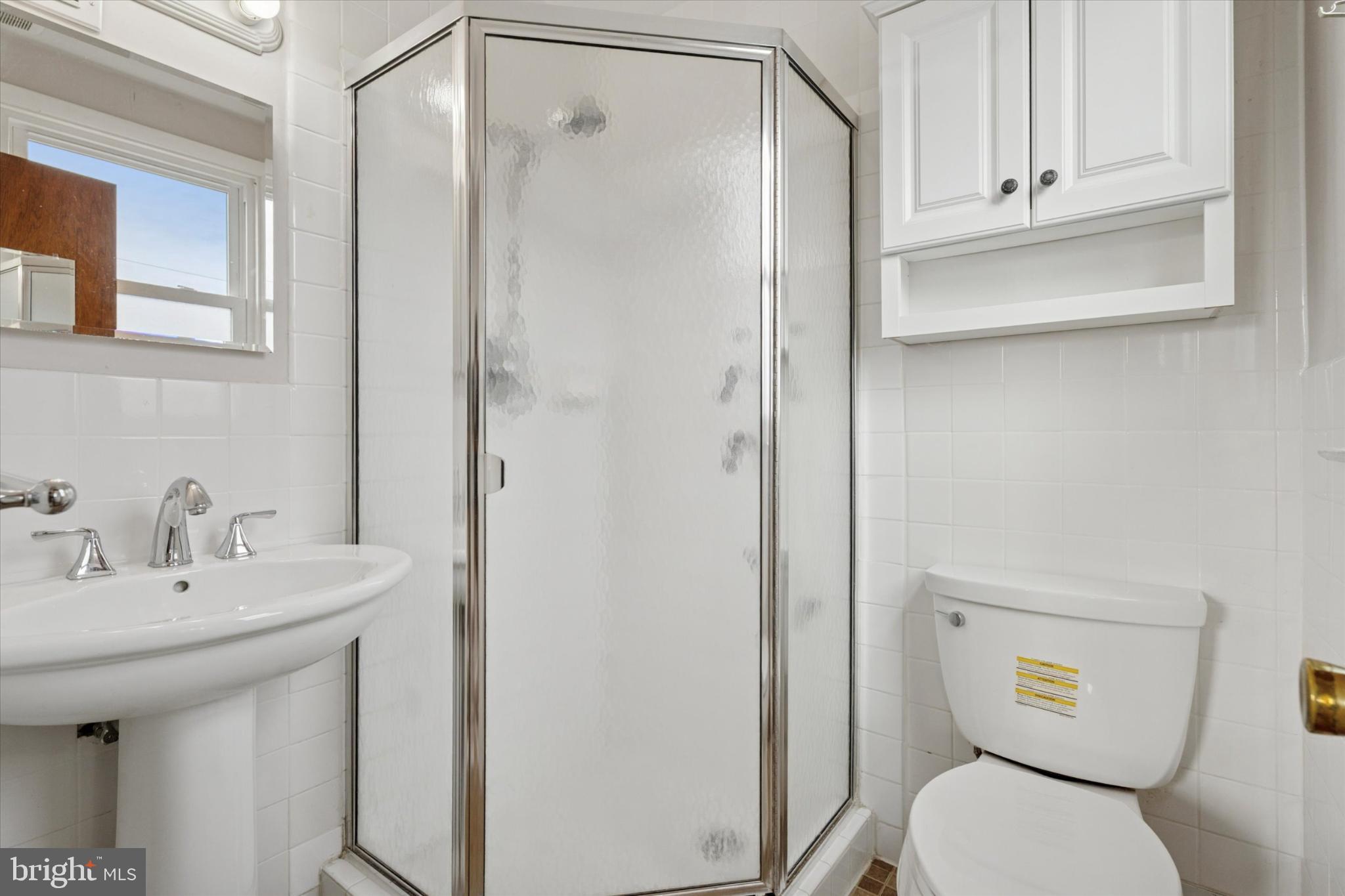 7429 Keiffer Street Philadelphia, PA 19128 - Photo 23 of 35 a bathroom with a sink a toilet and shower