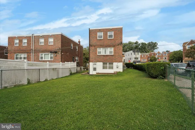 a view of an house with backyard space and balcony