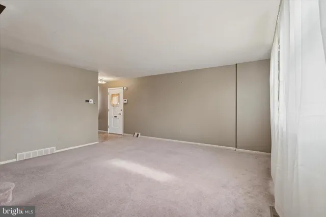 a view of an empty room and closet area