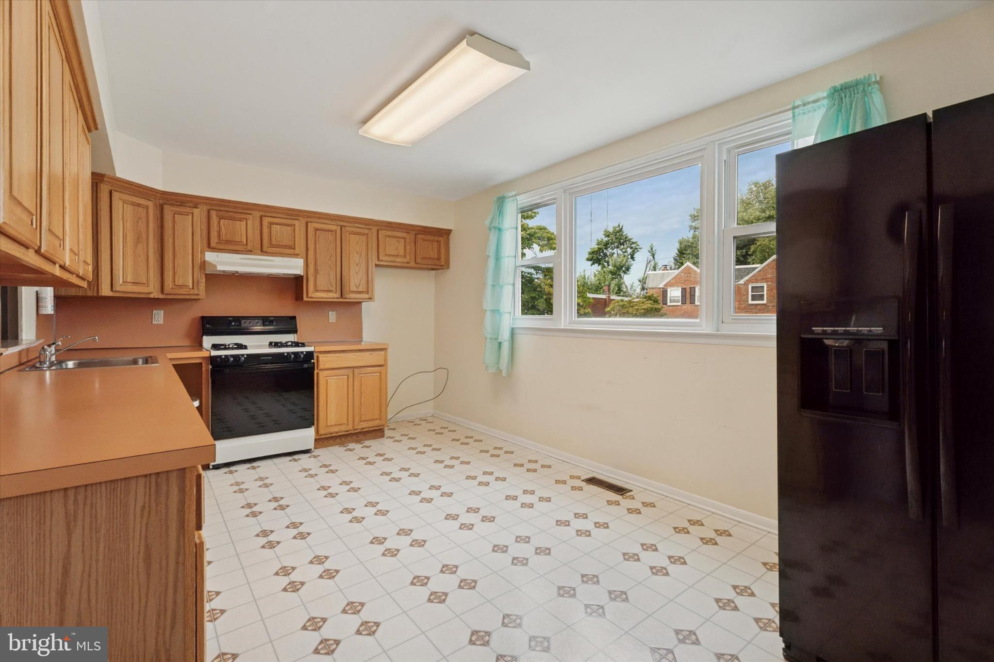 7429 Keiffer Street Philadelphia, PA 19128 - Photo 9 of 35 a kitchen with a refrigerator and a stove top oven