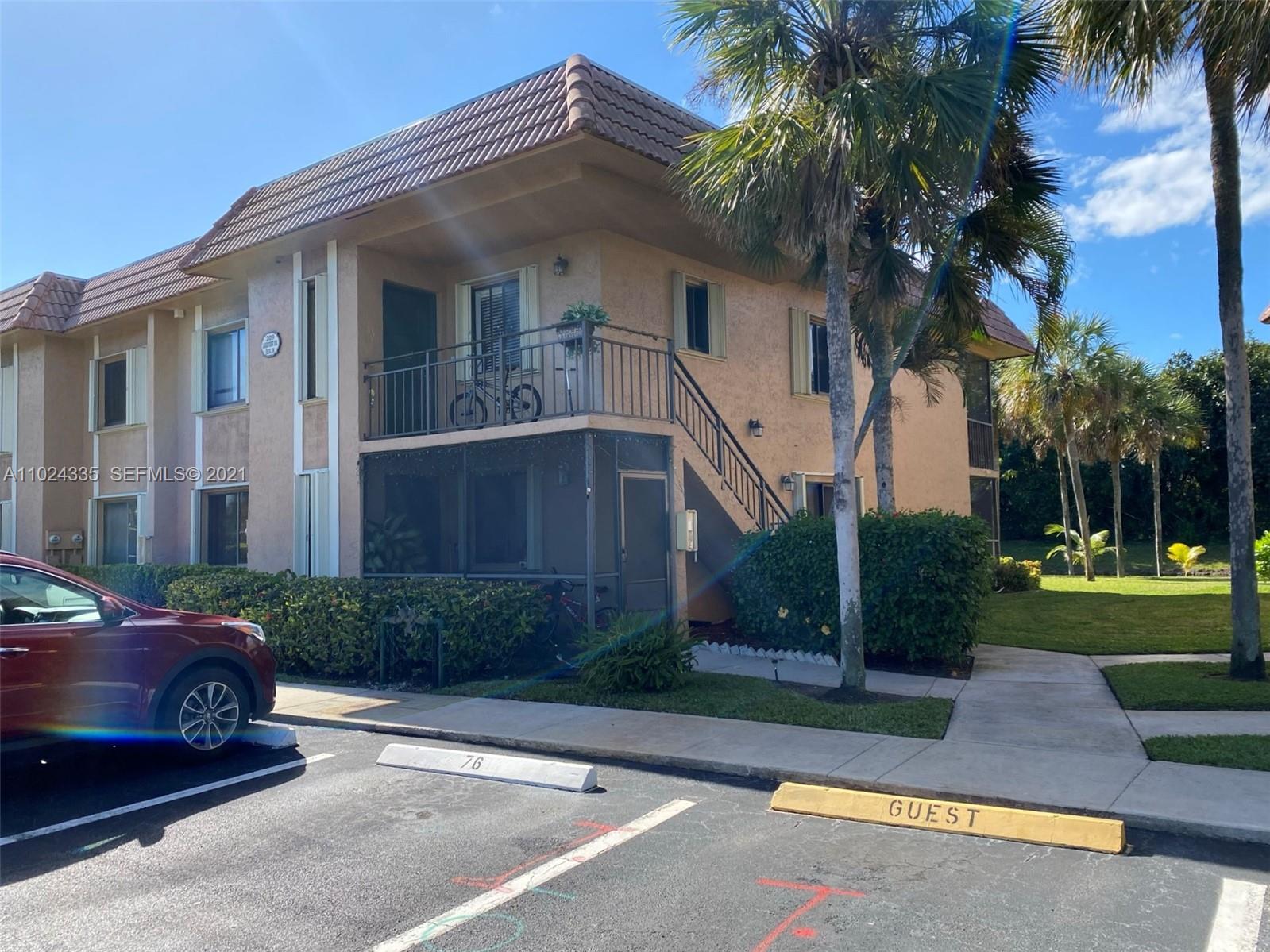 a front view of a house with a yard and a garage