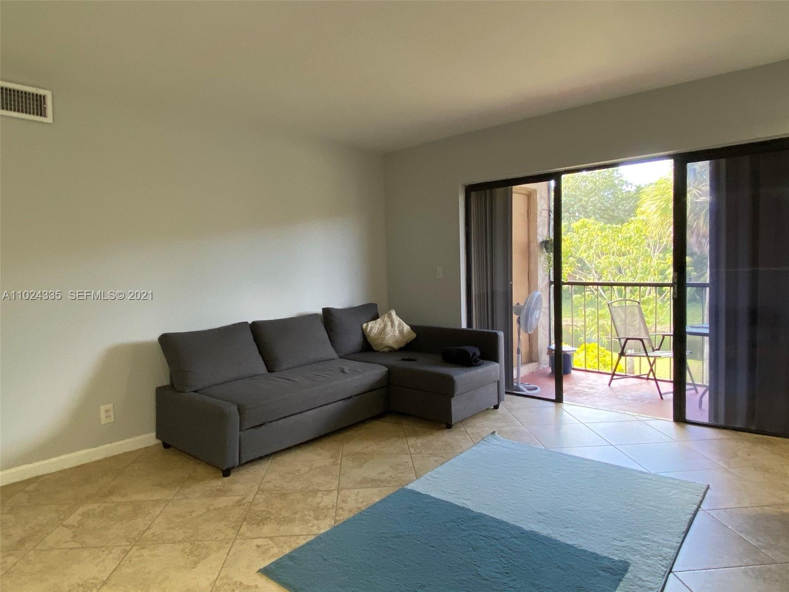 209 Lakeview Drive, Unit 202 Weston, FL 33326 - Photo 11 of 25 a living room with furniture and a large window