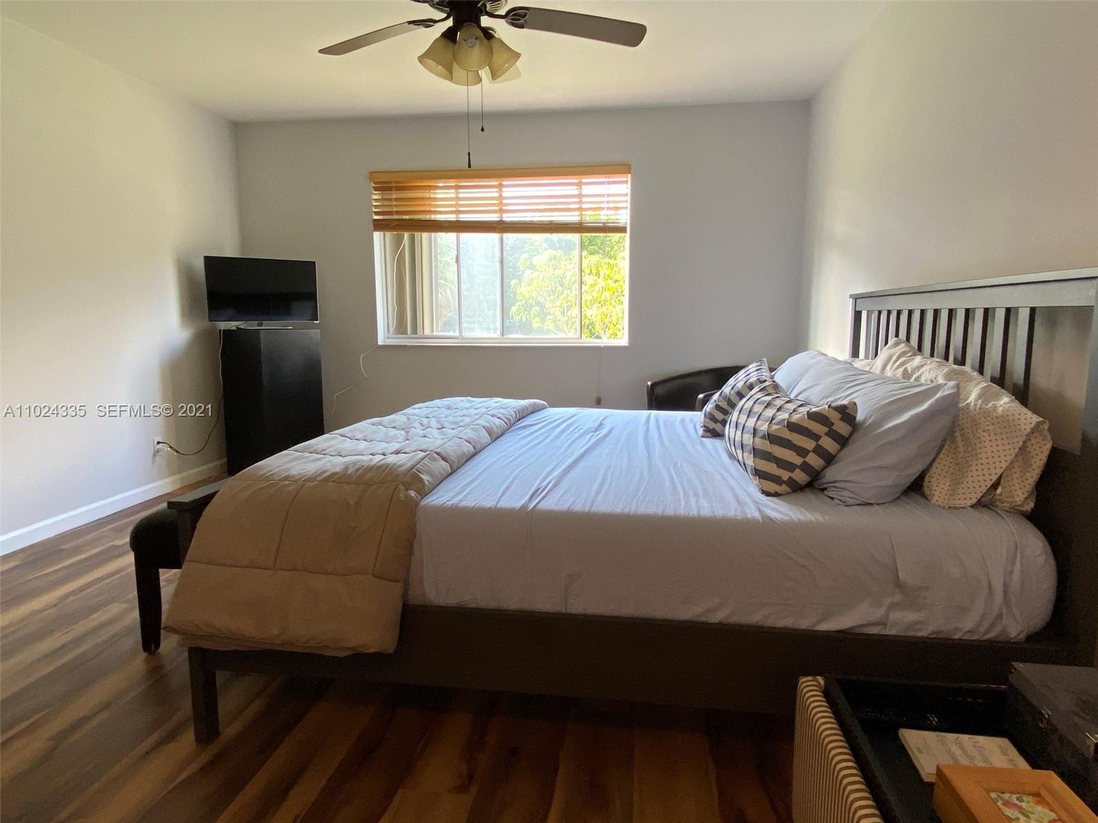 209 Lakeview Drive, Unit 202 Weston, FL 33326 - Photo 14 of 25 a bedroom with a bed and window