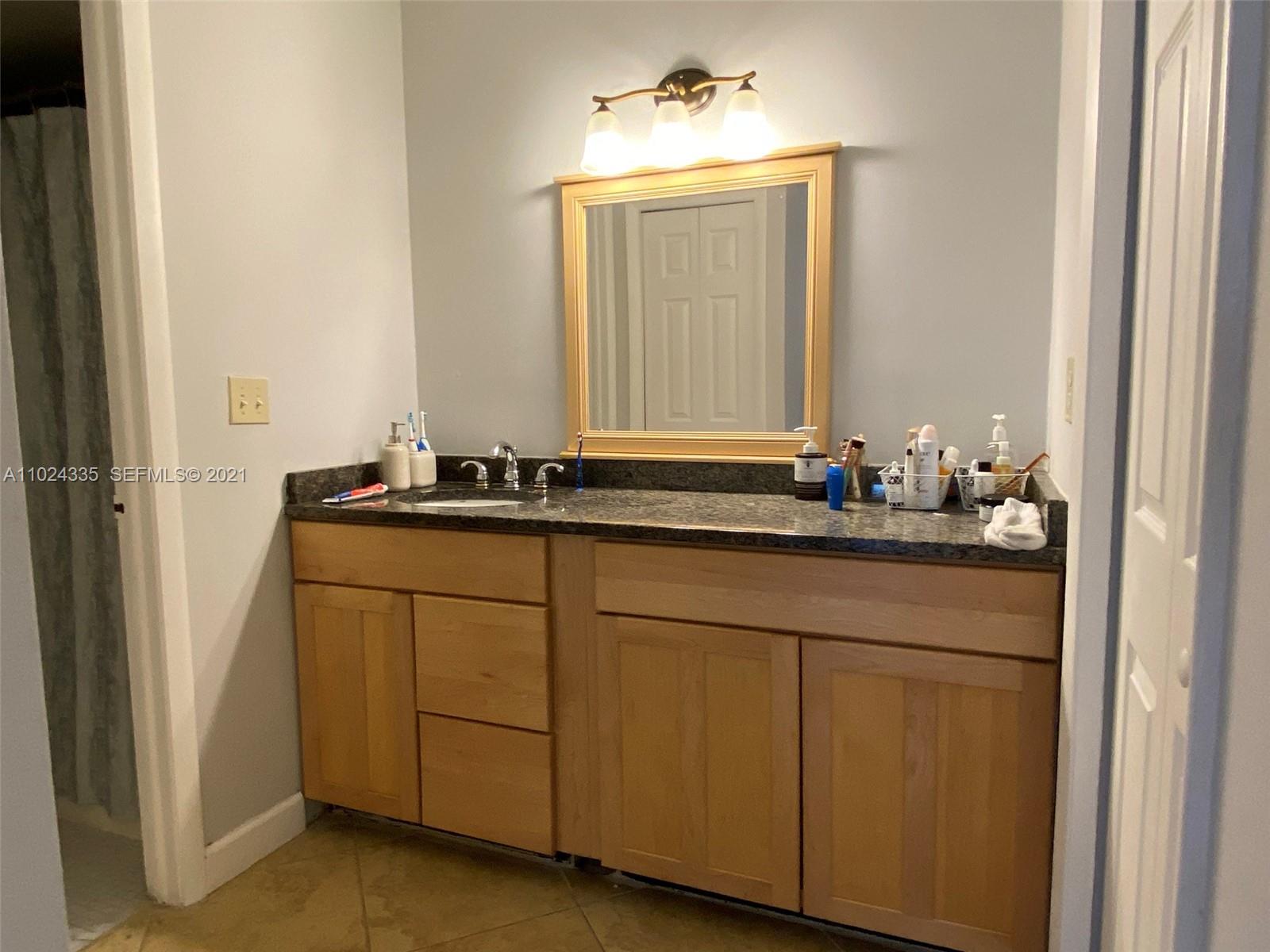 209 Lakeview Drive, Unit 202 Weston, FL 33326 - Photo 15 of 25 a bathroom with a sink and a mirror