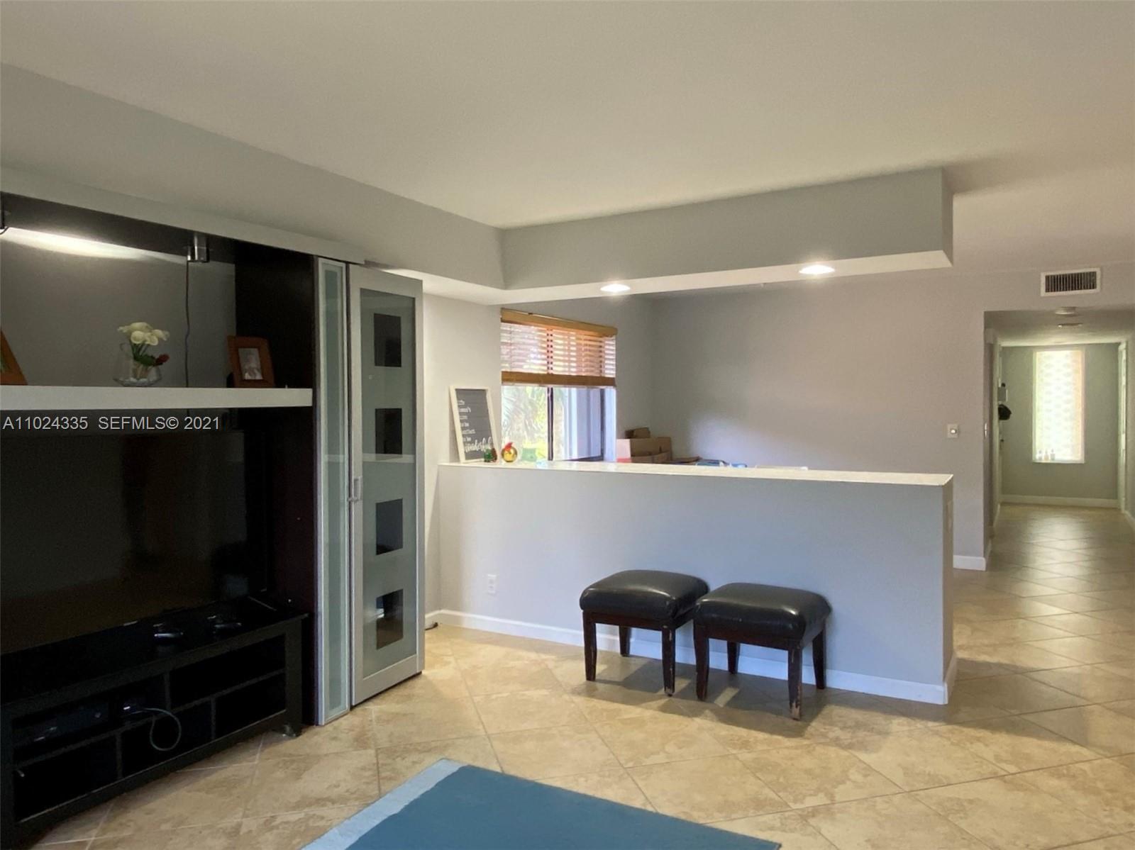 209 Lakeview Drive, Unit 202 Weston, FL 33326 - Photo 16 of 25 a workspace with furniture hardwood and a kitchen