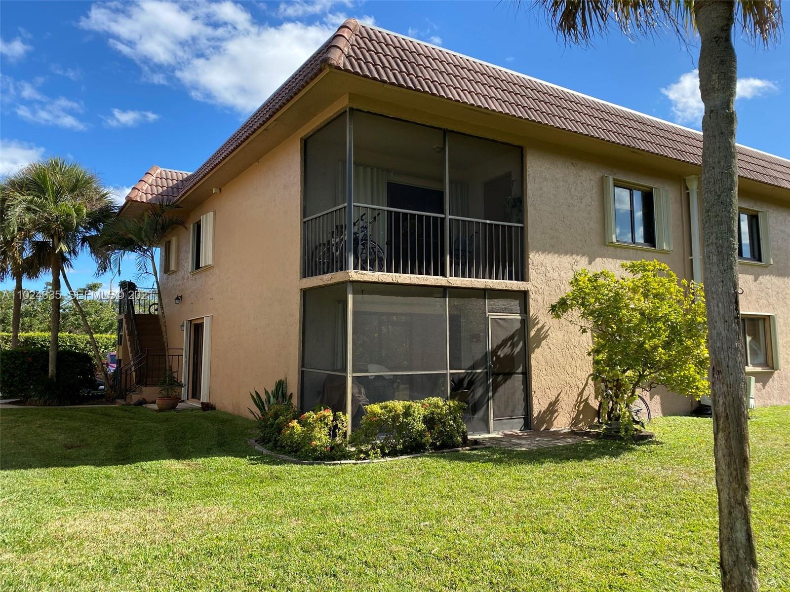 209 Lakeview Drive, Unit 202 Weston, FL 33326 - Photo 20 of 25 a front view of a house with a yard