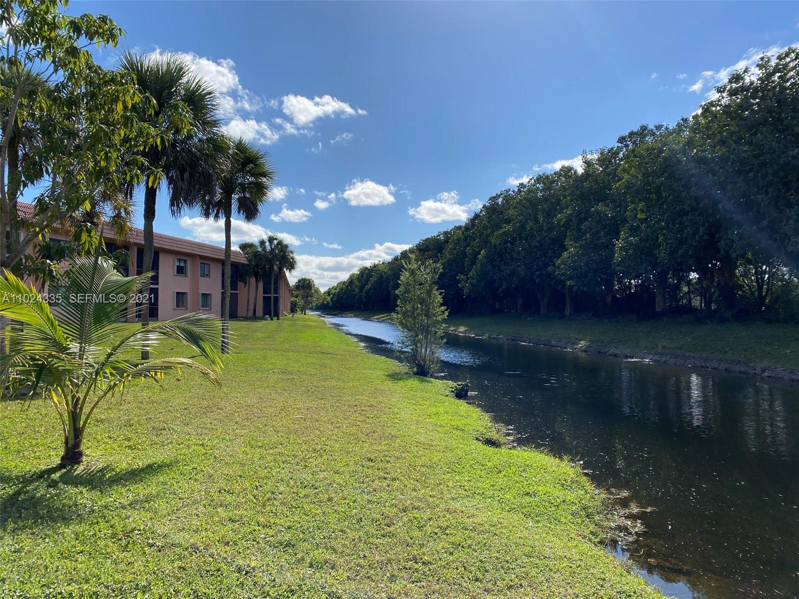 209 Lakeview Drive, Unit 202 Weston, FL 33326 - Photo 22 of 25 a swimming pool with outdoor seating and yard