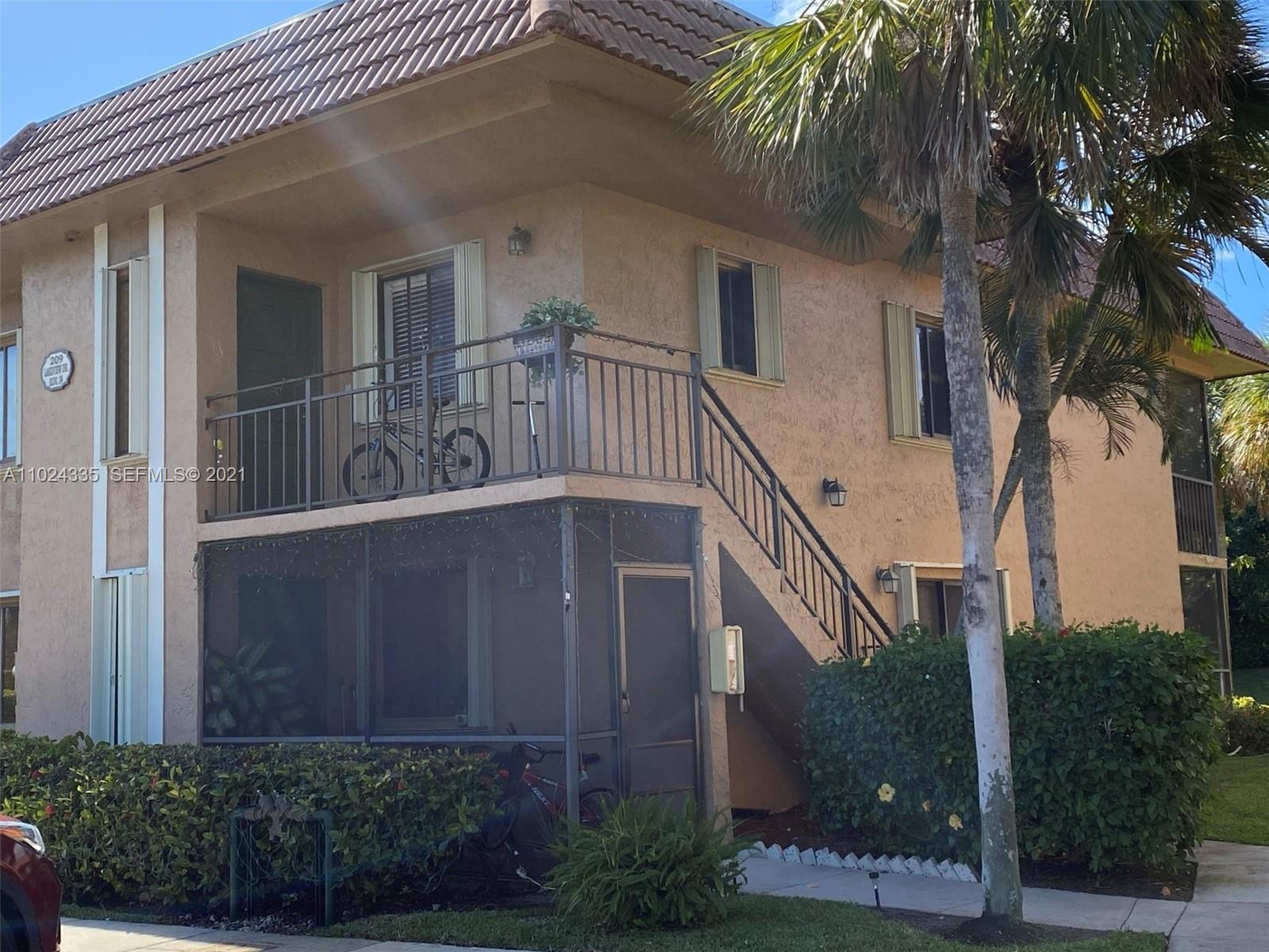 209 Lakeview Drive, Unit 202 Weston, FL 33326 - Photo 24 of 25 front view of a house with a small yard