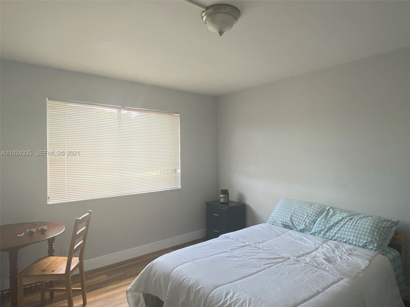 209 Lakeview Drive, Unit 202 Weston, FL 33326 - Photo 6 of 25 a bedroom with a bed and a window