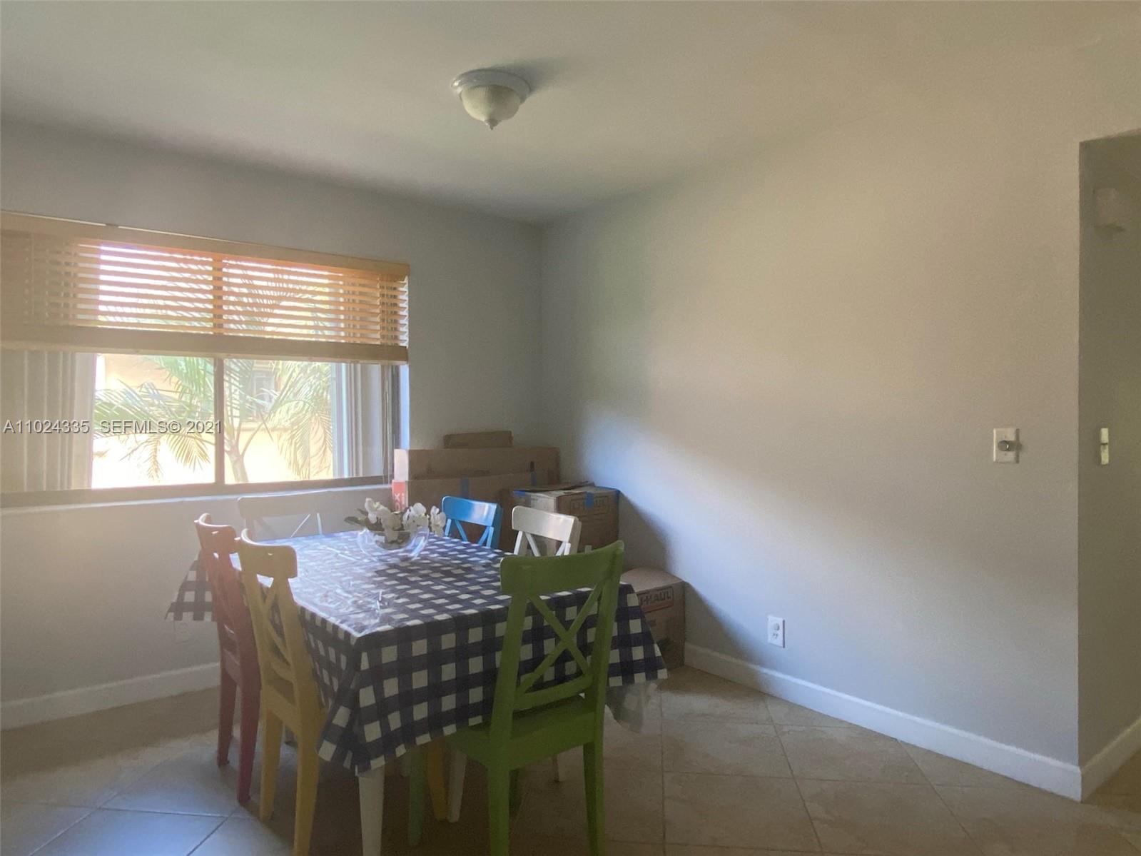 209 Lakeview Drive, Unit 202 Weston, FL 33326 - Photo 7 of 25 a dining room with furniture and window